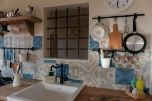 a kitchen with a sink and a counter with utensils at La Casetta Di Borgo in Lajatico +44 photos