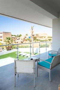 a patio with two chairs and a table on a balcony at Villa Lina in Agrigento