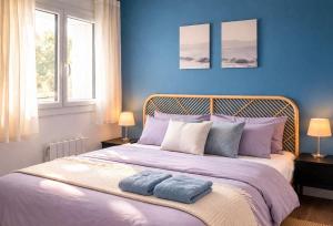 a blue bedroom with a bed with two towels on it at Le refuge Marin - Mer, Piscine, tennis & Loisirs à 2 pas in Cabourg +19 photos