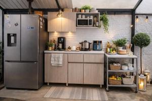 a kitchen with stainless steel appliances in a garage at Durán Business Suites near Airport in Bogotá