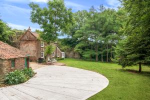 a wooden walkway in front of a house at Idyllic Waterside Cottage in Mid Devon in Tiverton