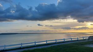 a view of a body of water with a fence at Les 3 conserveries in Le Crotoy