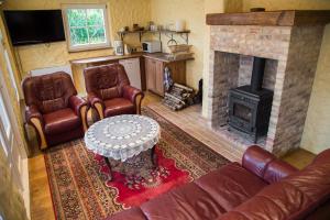 a living room with a couch and a fireplace at Posti Hostel in Kärdla