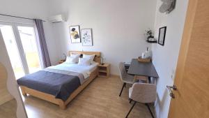 a bedroom with a bed and a table and a desk at Rooms-Sobe Haus Magdalena Krk in Krk