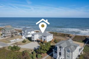 an aerial view of a house by the ocean at 4110 - Coop's Cottage in Duck