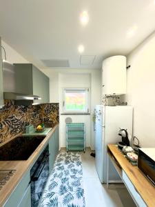 a kitchen with a counter and a refrigerator at JungleHouse in Abbadia Lariana