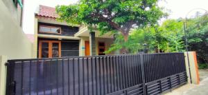 a black fence in front of a house at Sabi House Sardjono in Yogyakarta