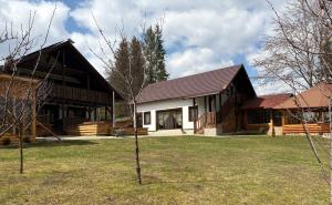 a log home with a gambrel roof at Hanna's Hidden Haven in Harghita-Băi
