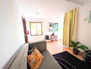 a living room with a couch and a table at Paul do Mar view in Paul do Mar