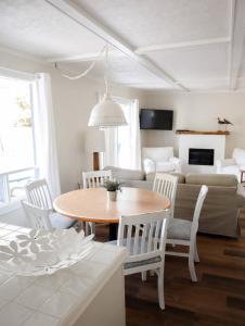a living room with a table and chairs and a couch at Beachside on Lake Muskoka in Port Carling