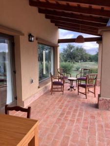 a patio with chairs and a table and windows at Casa Nidito San Javier in San Javier