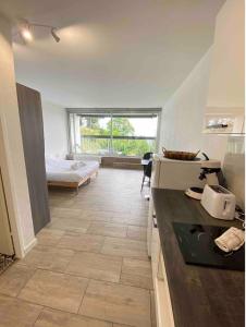 a kitchen with a counter and a bed in a room at - Le Belvédère - in Turckheim