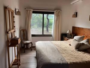 a bedroom with a large bed and a window at Casa Nidito San Javier in San Javier +17 photos