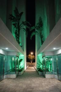 a hallway of a building at night with plants at La Loma in Águilas +8 photos