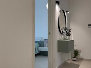 a hallway with a mirror on the wall and a table at Ferraro Apartments in Campora San Giovanni