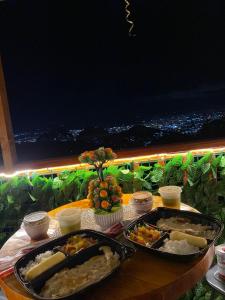 a table with two trays of food on it at Glamping NOVA VILLA EL EDEN in Cali