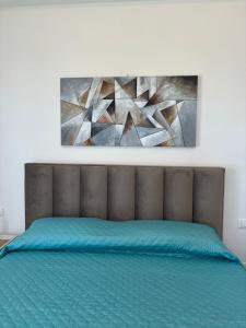 a bed in a bedroom with a painting on the wall at Villa Lina in Agrigento +63 photos