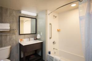 a bathroom with a shower, toilet, sink and tub at Hotel Azure in South Lake Tahoe