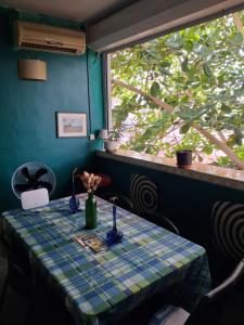 a table in a room with a window at Chez Brahim in Pointe-à-Pitre