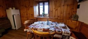 a dining room with a table and a refrigerator at La Maison de Vetan in Saint-Pierre