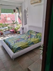a bed in a room next to a window at Chez Brahim in Pointe-à-Pitre