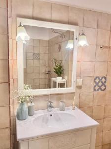 a bathroom with a sink and a mirror at Veneziana Liston view apt in Corfu +32 photos