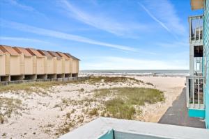 a view of the beach from the balcony of a beach house at Coastal Condo Steps from the Beach in Gulf Shores
