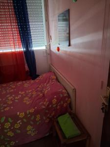a small bedroom with a bed and a window at Chez Brahim in Pointe-à-Pitre