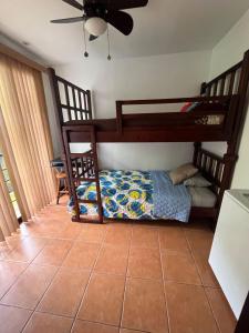 a bedroom with two bunk beds at Condo Mono Titi in Quepos +13 photos