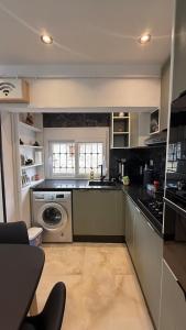 a kitchen with a sink and a dishwasher at Olivia Loft in Birmandreis +87 photos