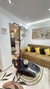a living room with a couch and a table at Olivia Loft in Birmandreis