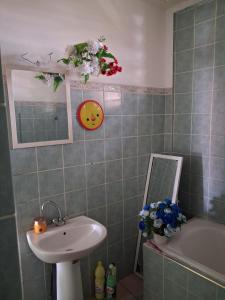 a bathroom with a sink and a toilet and a mirror at Chez Brahim in Pointe-à-Pitre