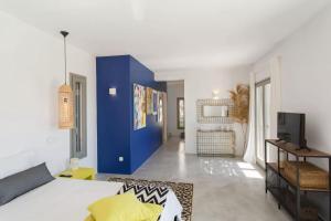 a living room with a blue accent wall at Callirhoe 180 in Poros