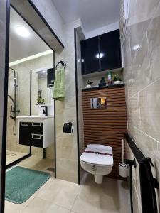 a bathroom with a toilet and a sink at Olivia Loft in Birmandreis