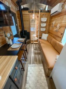 a living room with a couch and a table at The Self-Care Tiny Cabin in Parsons