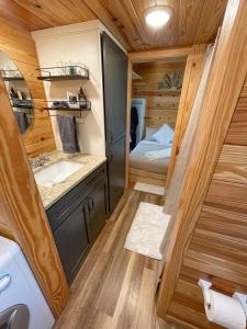a small bathroom with a sink and a toilet at The Self-Care Tiny Cabin in Parsons +24 photos