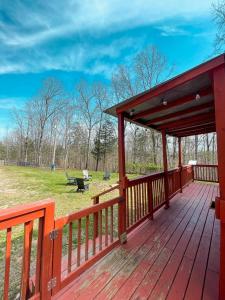 a wooden deck with a picnic table on a field at The Self-Care Tiny Cabin in Parsons