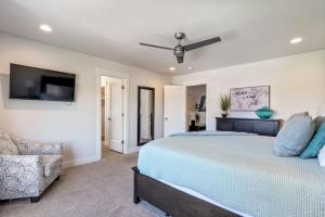 a bedroom with a large bed with a ceiling fan at Townhome Near Zion with Hot Tub & Pool in Washington