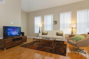 a living room with a couch and a tv at Madera in Mountain View