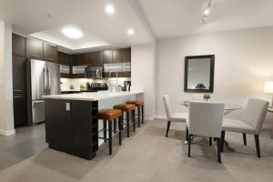 a kitchen and dining room with a table and chairs at Madera in Mountain View
