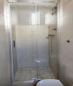 a bathroom with a shower with a toilet in it at Maison RG in Torre Canne