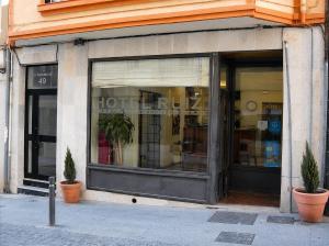 a store window with two potted plants in front of it at Hostal Ruiz in Soria