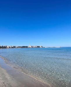 a view of the ocean with a beach and buildings at Maison RG in Torre Canne