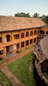 a large brick building with a canal in front of it at Premier Cabins in North Legon