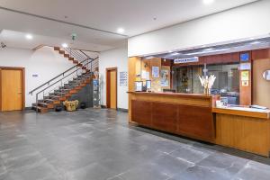a lobby with a staircase and a counter in a building at HI Douro Alijó - Pousada de Juventude in Alijó