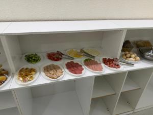 a refrigerator filled with lots of different types of food at ART Dream Hotel in Tashkent