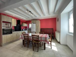 a kitchen and dining room with a table and chairs at Etchechoury in Moncayolle-Larrory-Mendibieu