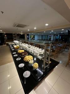 a buffet of food on a table in a restaurant at Green Hotéis in Cabo Frio
