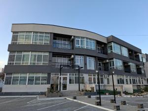 a large black building with a lot of windows at LA PLAYA - Studiouri pe plaja cu sezlong inclus in Eforie Nord