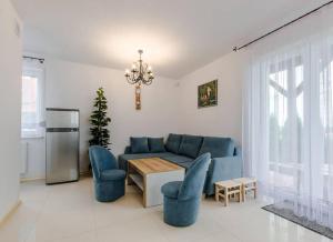 a living room with a blue couch and blue chairs at Ryn - Rybical Resort in Rybical